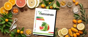Korice knjige Vitaminologija na drvenom stolu okružene citrusima i suplementima